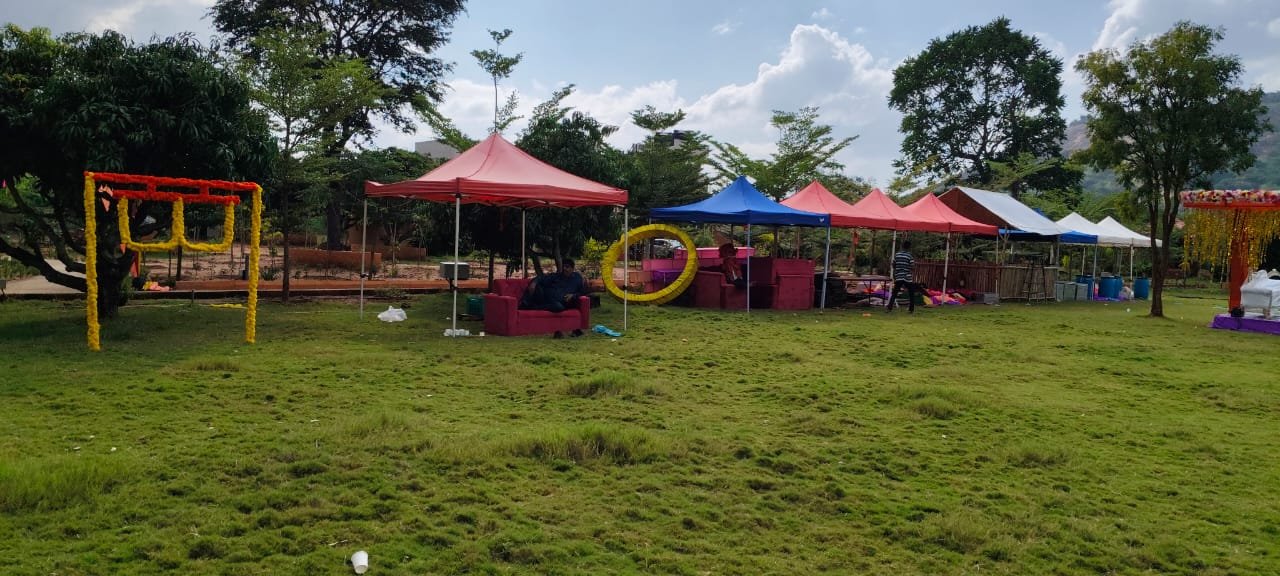 Colourful celebration setup beneath fabric canopies