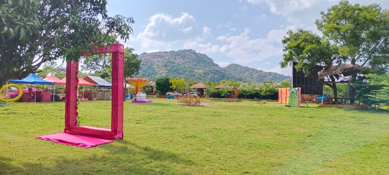 Event lawn framed by hills and colourful decorations